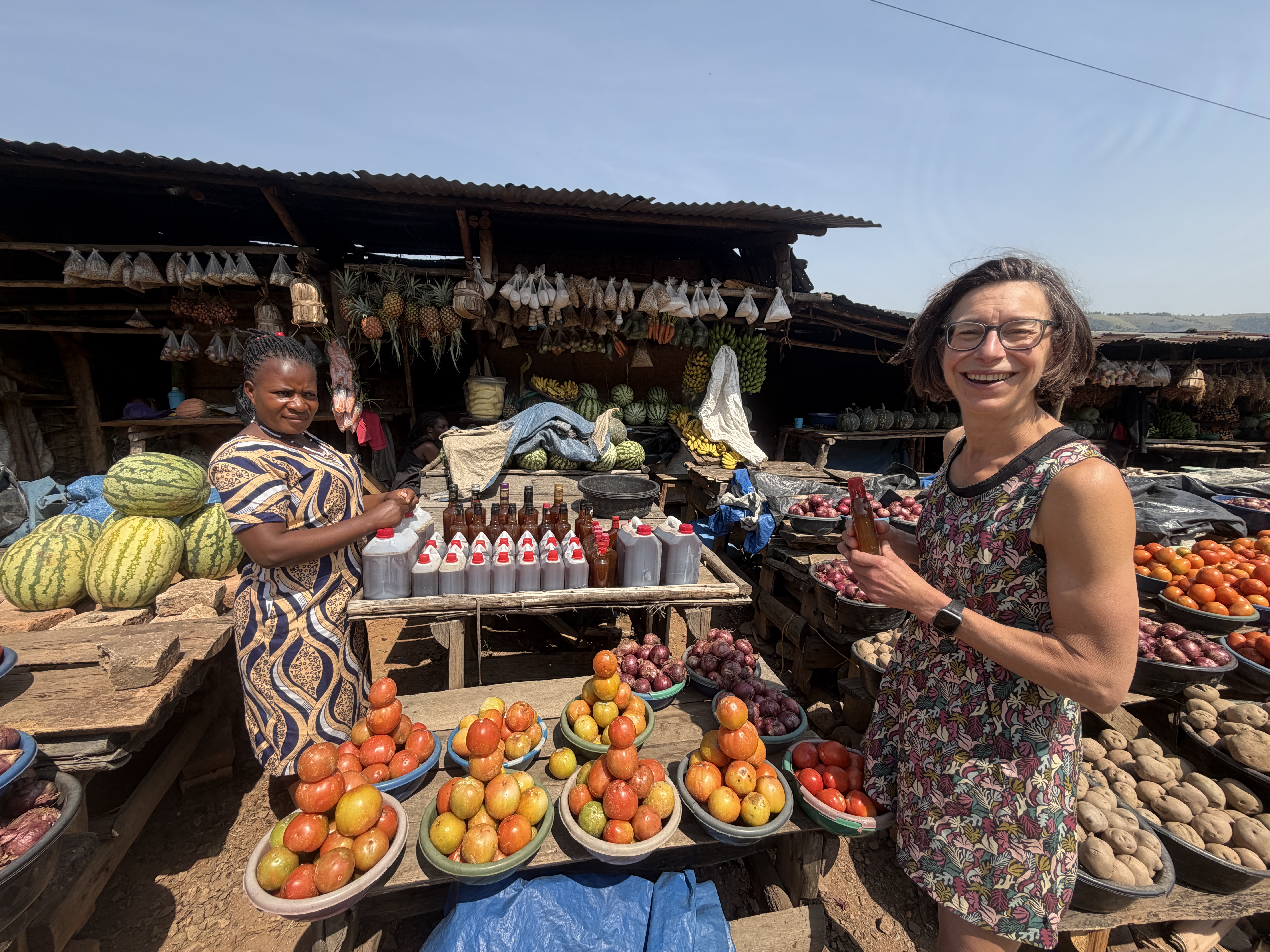 A guest visiting a vibrant local market as part of a community tourism experience.